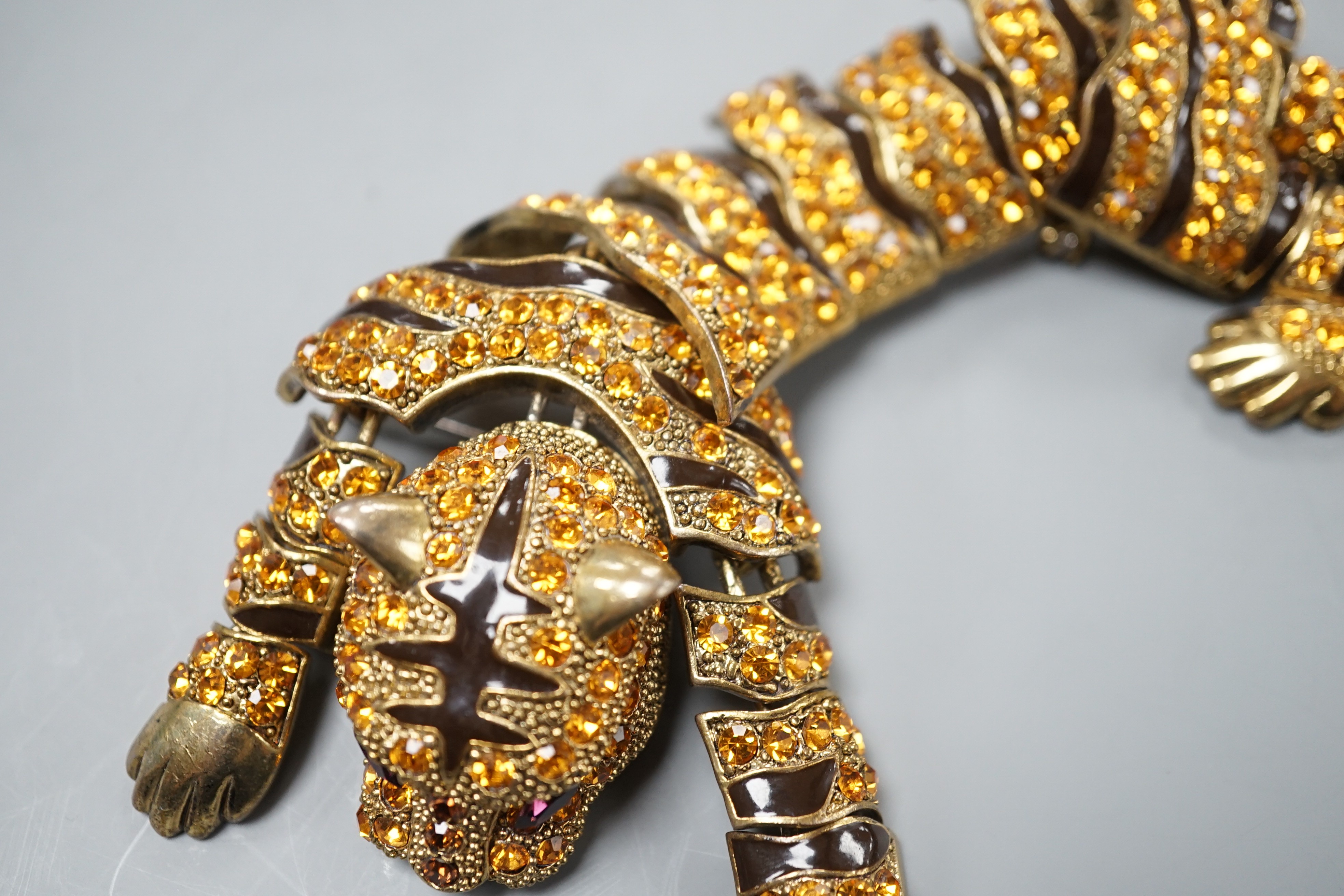 A costume gilt metal and paste set tiger shoulder? ornament, 24.5cm.